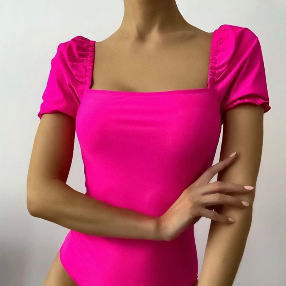 Woman’s new hot pink bathing suit with puffed short sleeves